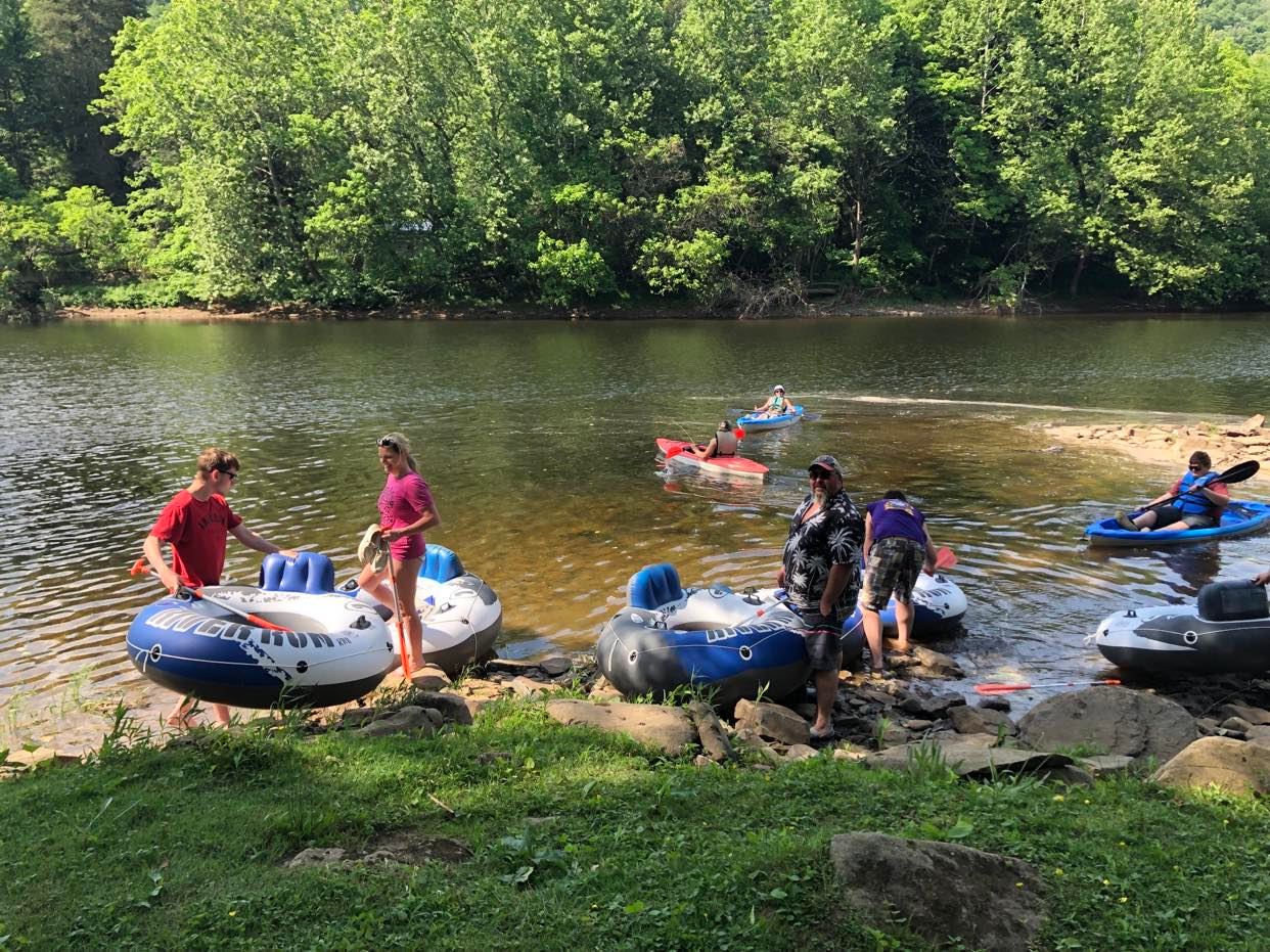 A family in tubes and kayaks on the river